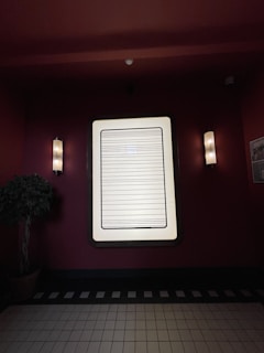 Smart lighting control panel glowing softly beside a richly lit commercial interior