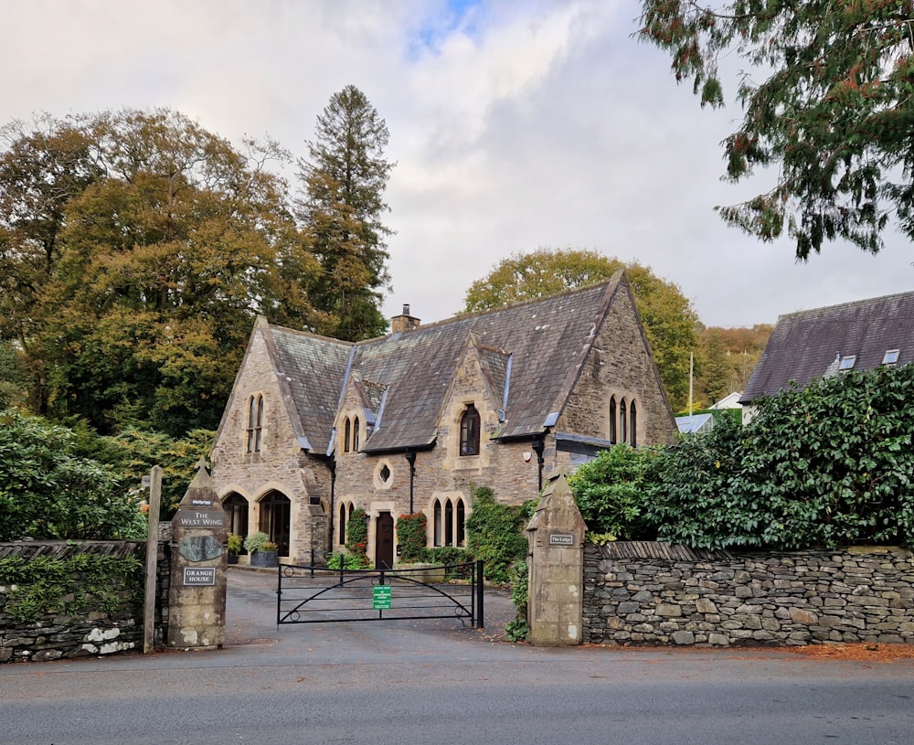 a stone building with a fence around it