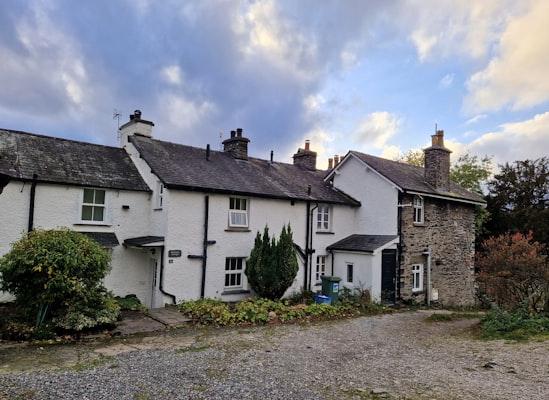 Traditional whitewashed Lake District cottages with slate roofs and stone chimneys in Cumbria