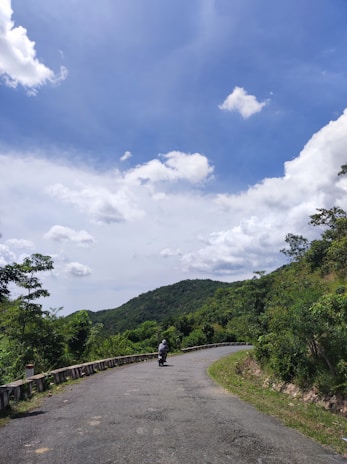 A scenic Baltic landscape with winding roads perfect for motorcycle adventures, under a clear blue sky.