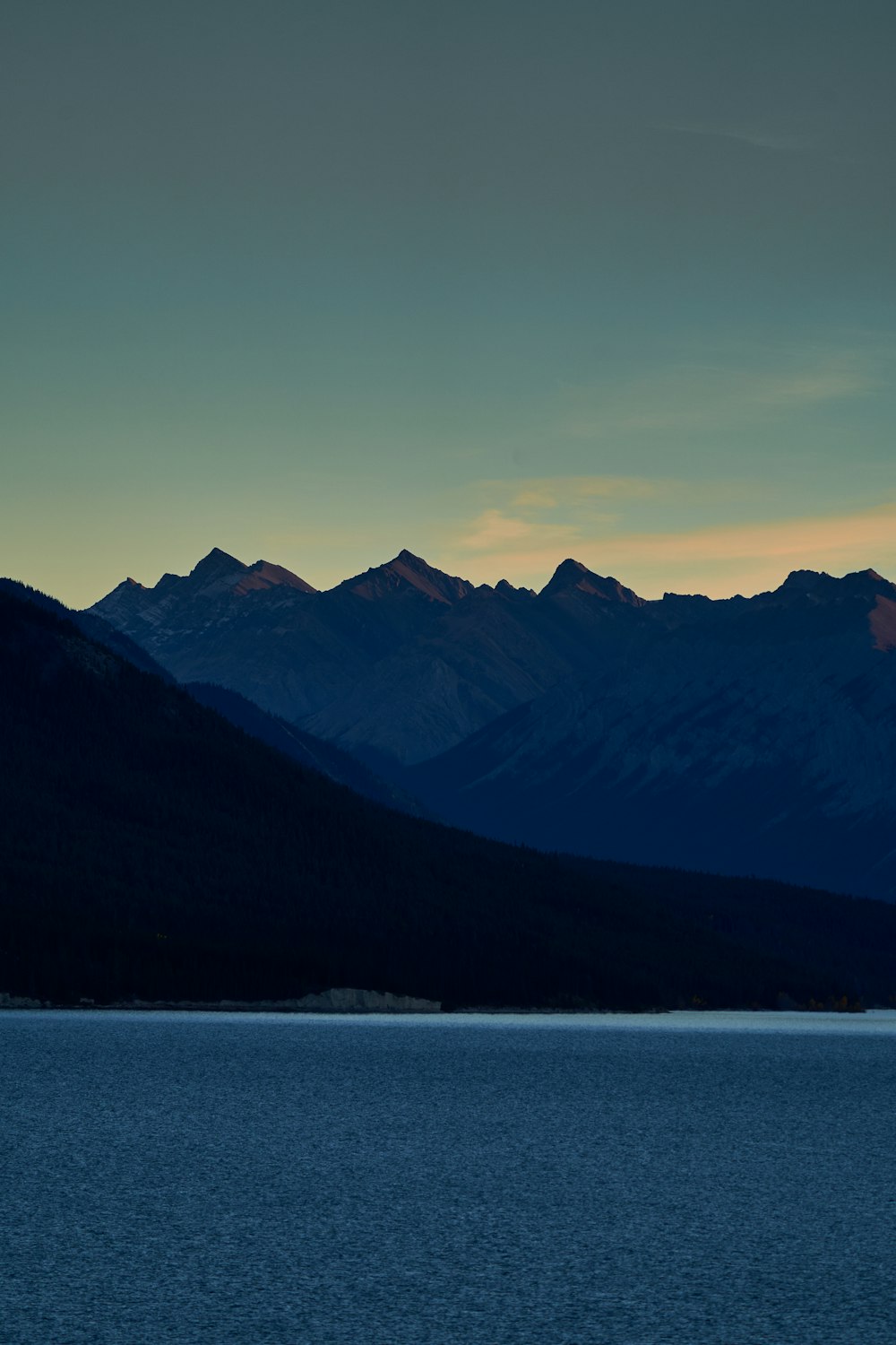 a body of water with mountains in the background