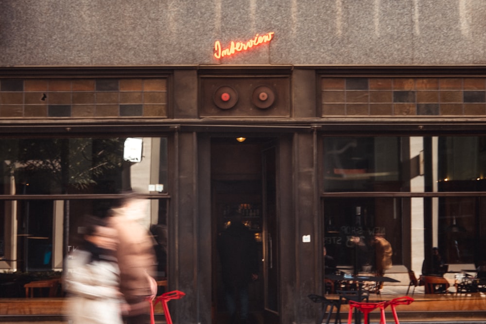 a person walking in front of a restaurant