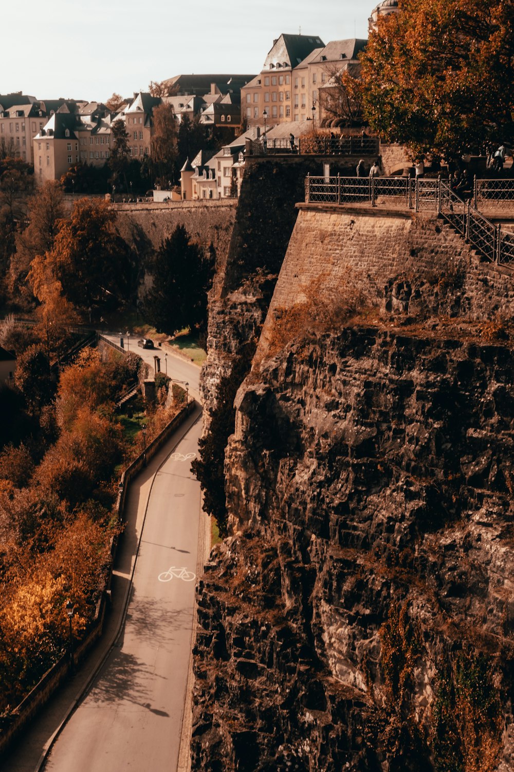 a road with a bridge and buildings on the side