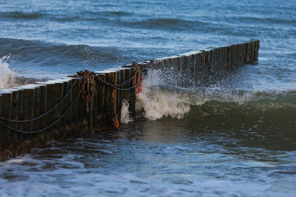 a wave crashing into a pier
