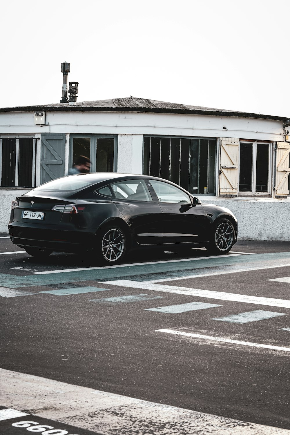 a black car parked in front of a building