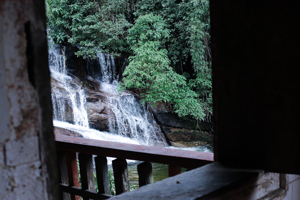 a waterfall with a bridge