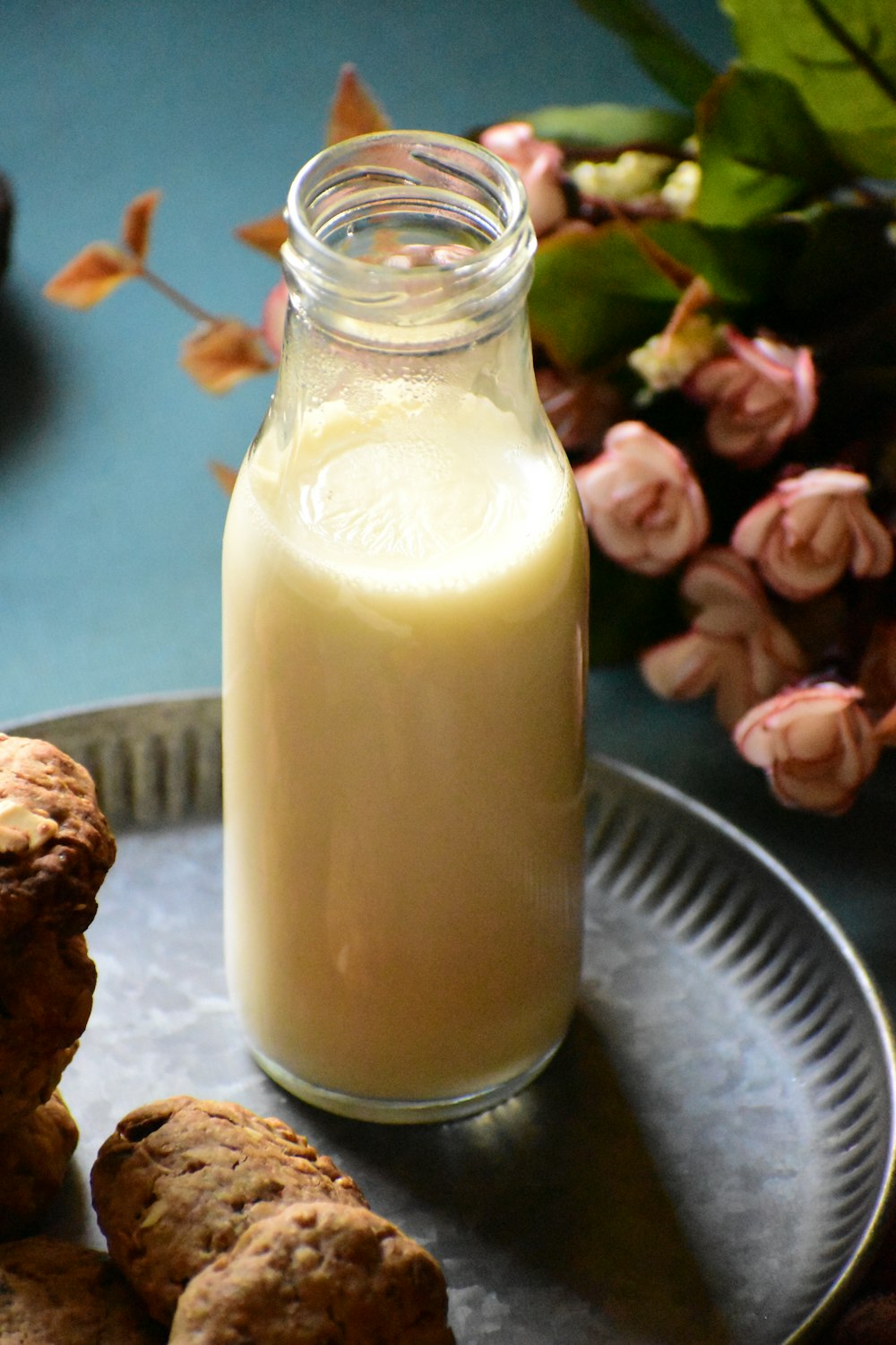 a glass jar with a white substance and brown objects in it