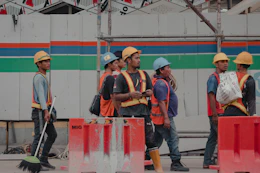 Construction workers in hard hats and vests on site