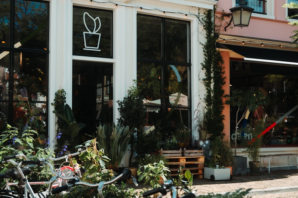 a building with plants and bikes outside