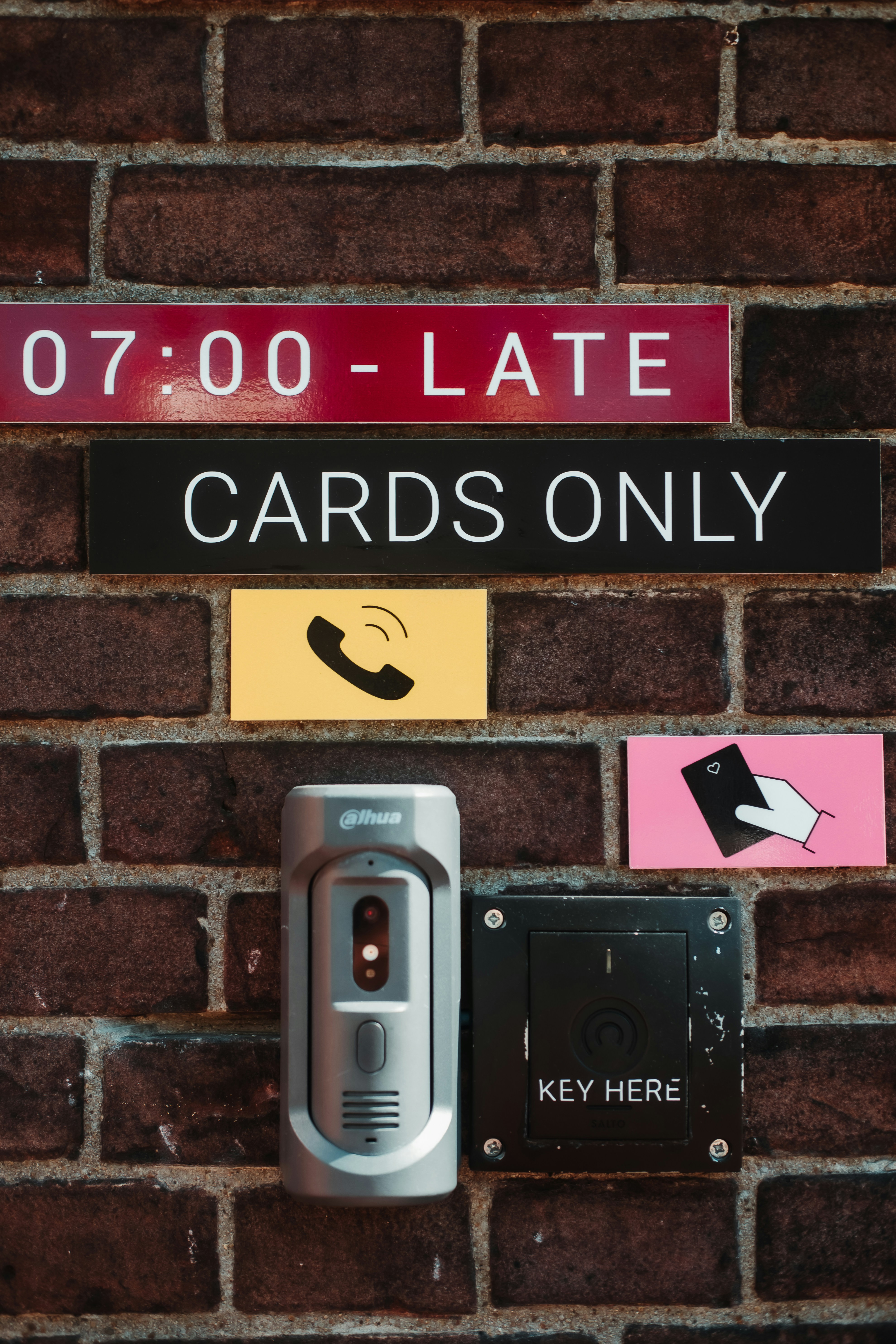 Security access control system with key card reader on brick wall.