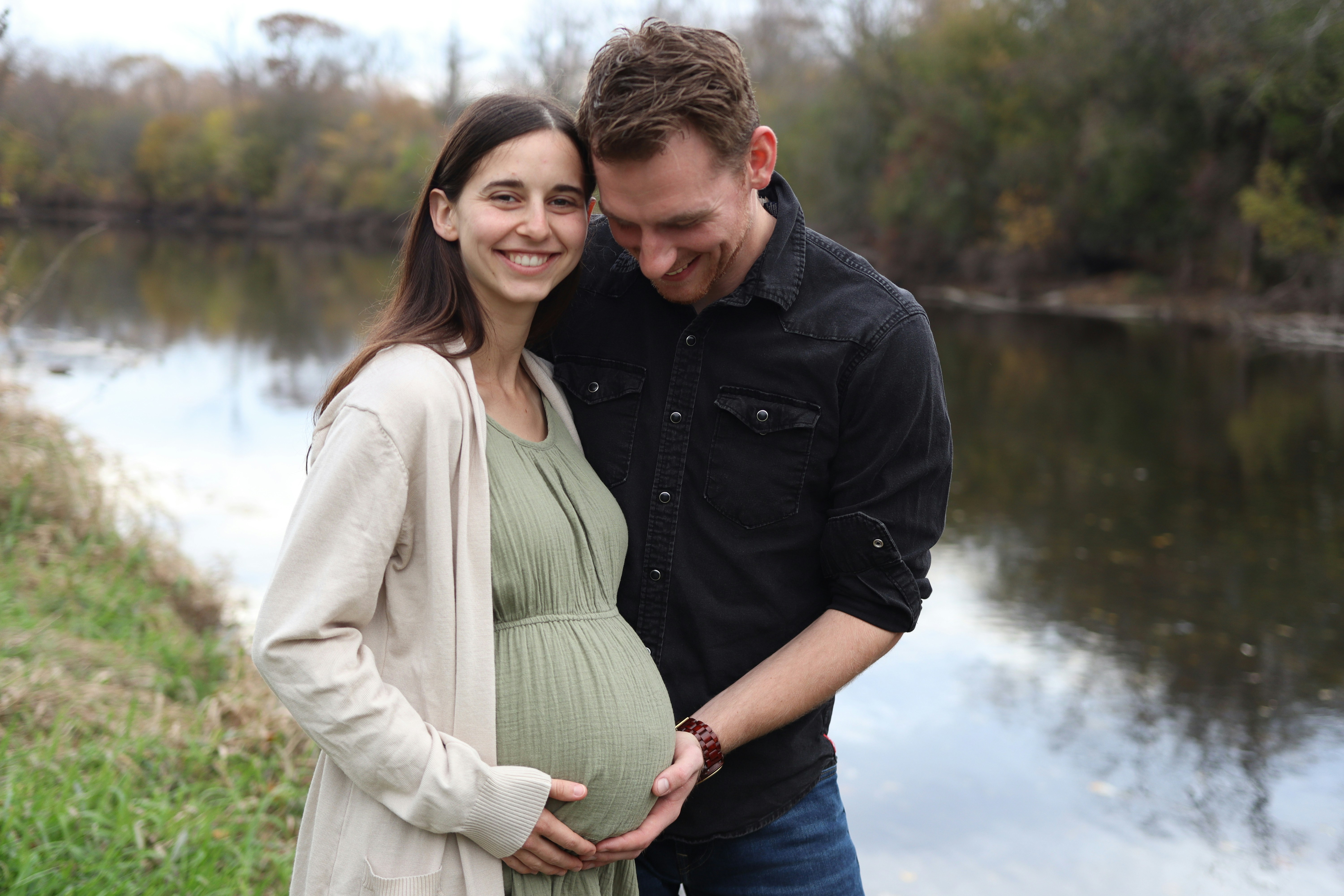 Pregnant woman holding ultrasound near belly