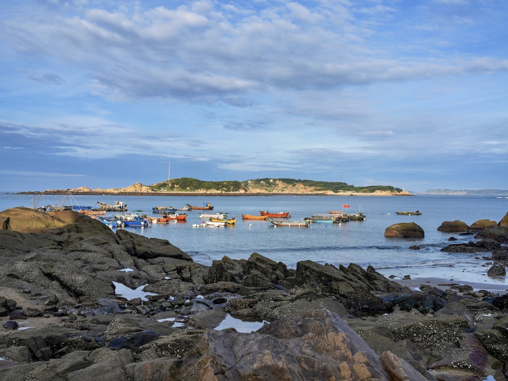 a rocky beach with boats