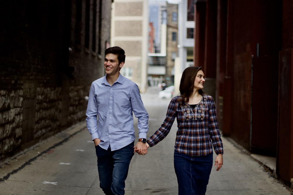 a man and woman walking down a street