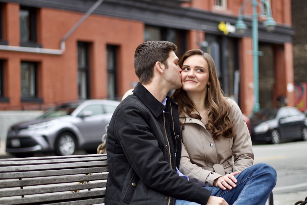 a man and woman sitting on a bench