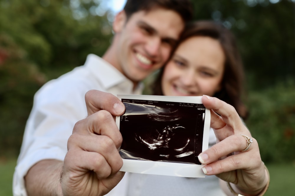 a man and woman looking at a cell phone