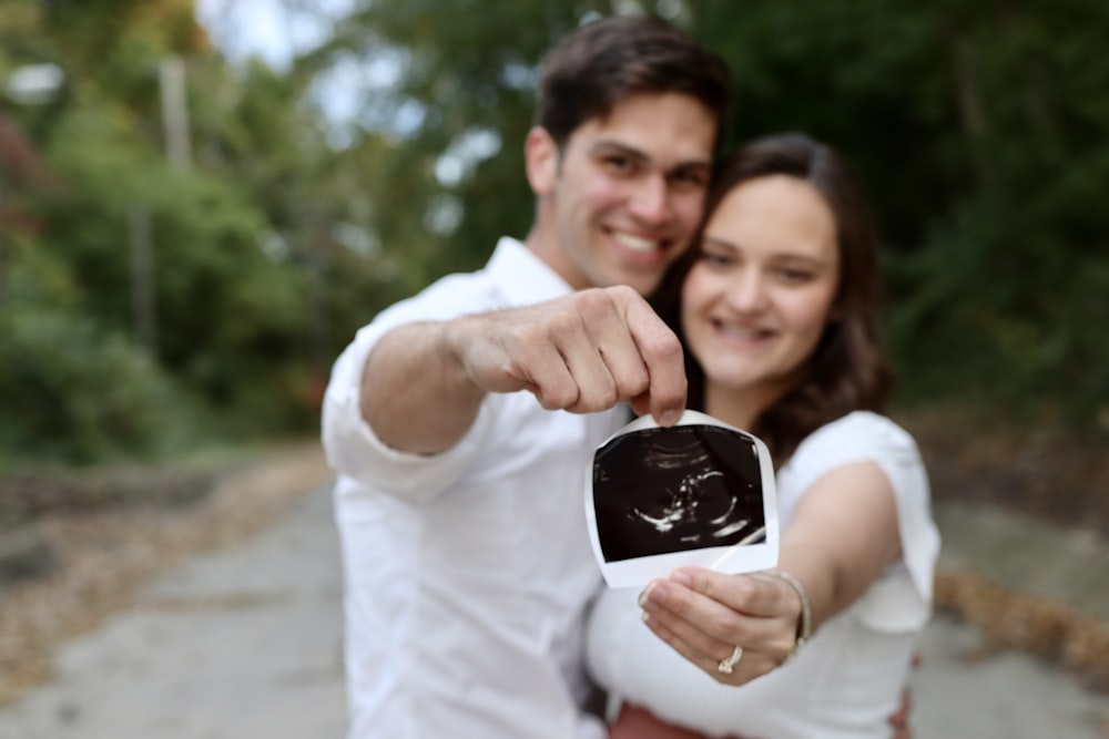 a man and woman holding a black object