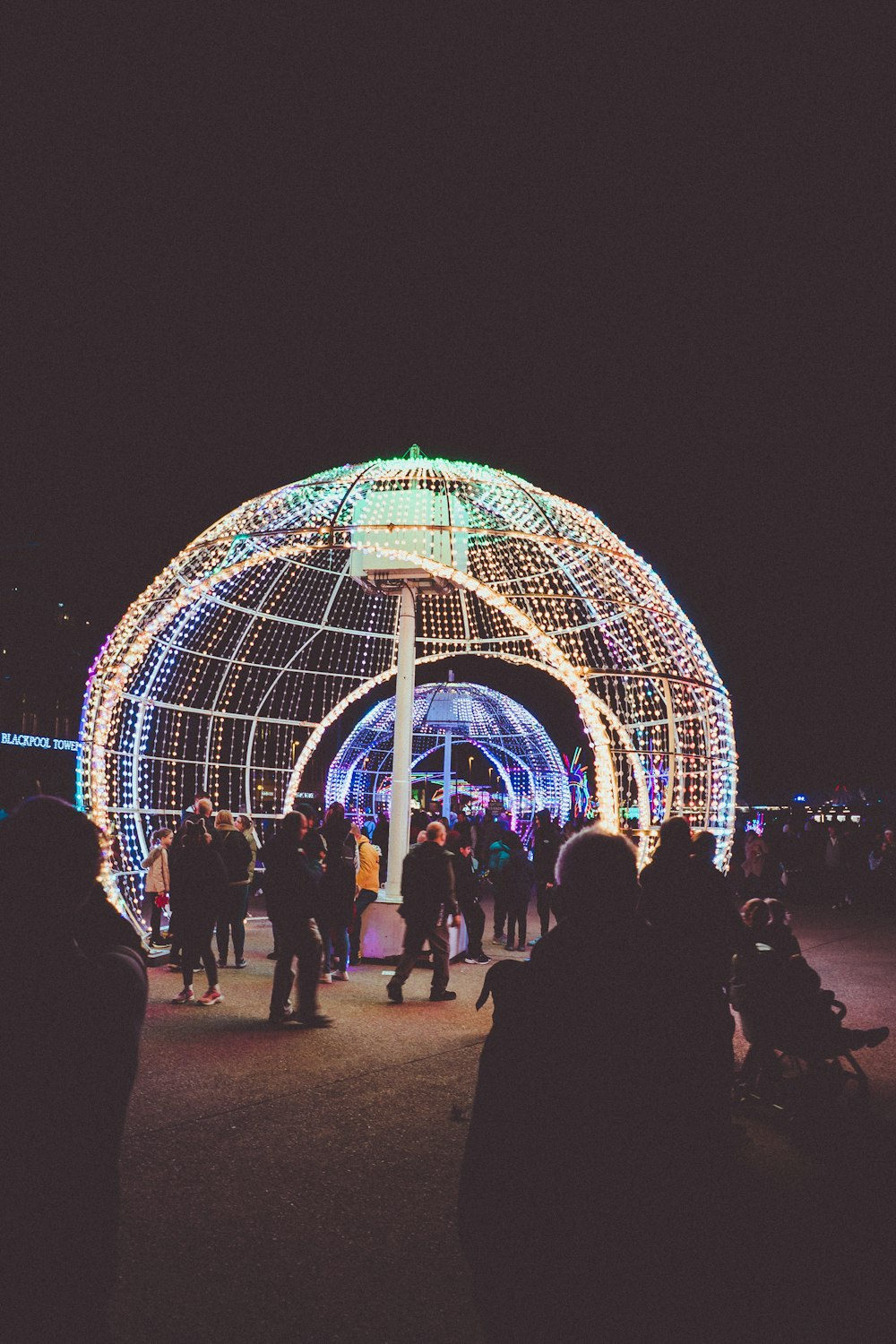 a group of people standing in front of a dome shaped building