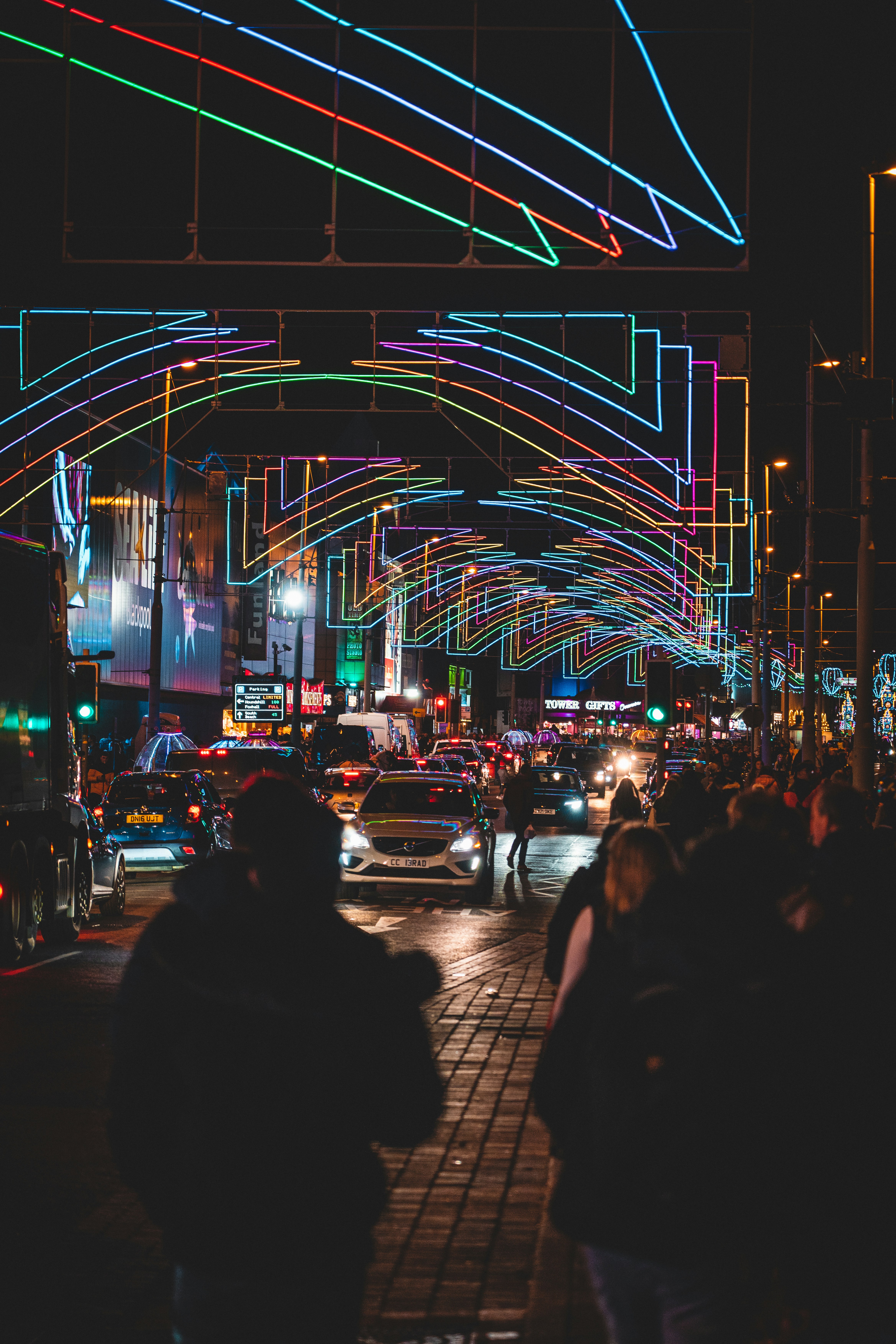 a busy street with cars and people