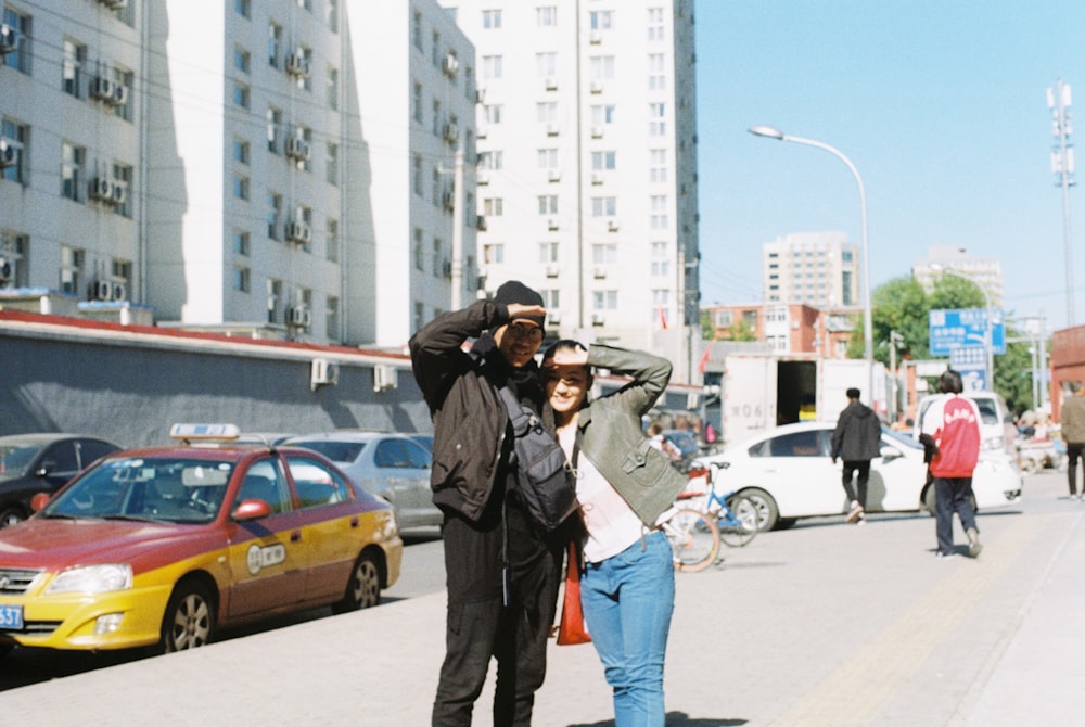 a man and woman standing on a street corner