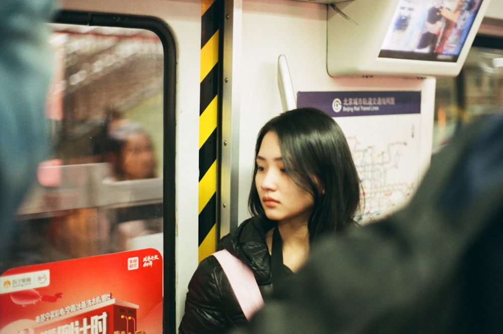 a woman sitting in a train