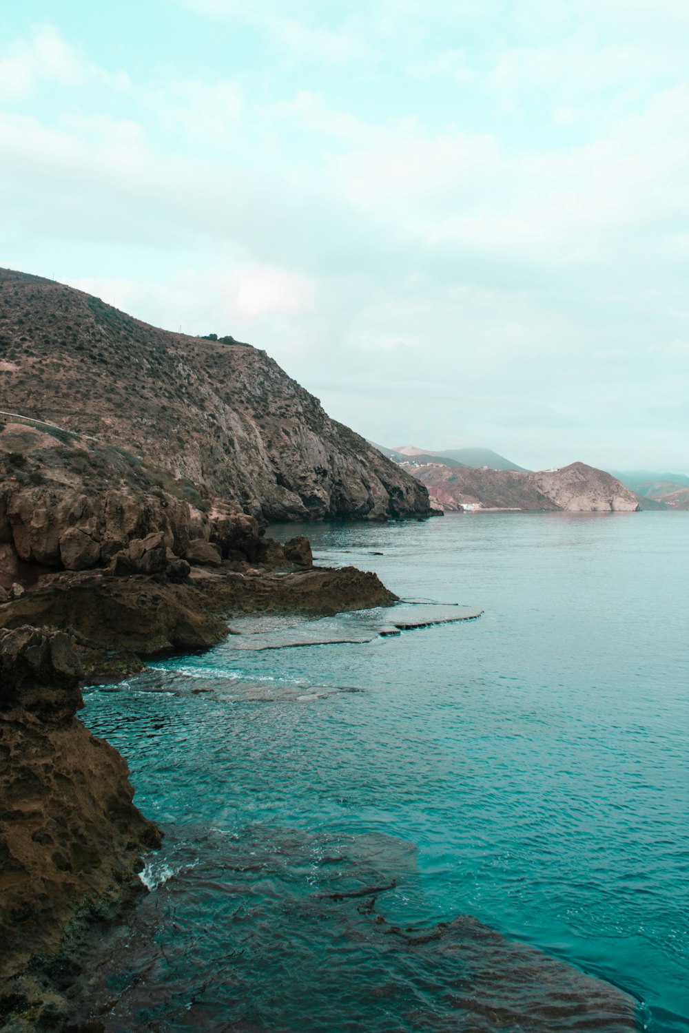 a body of water with rocky cliffs