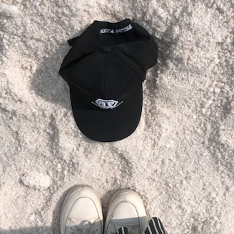 Close-up of a stylish Toronto Cricket Co. cap resting on a cricket pitch.