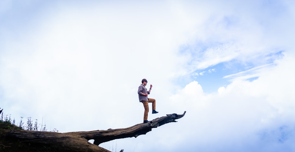 a man standing on a log