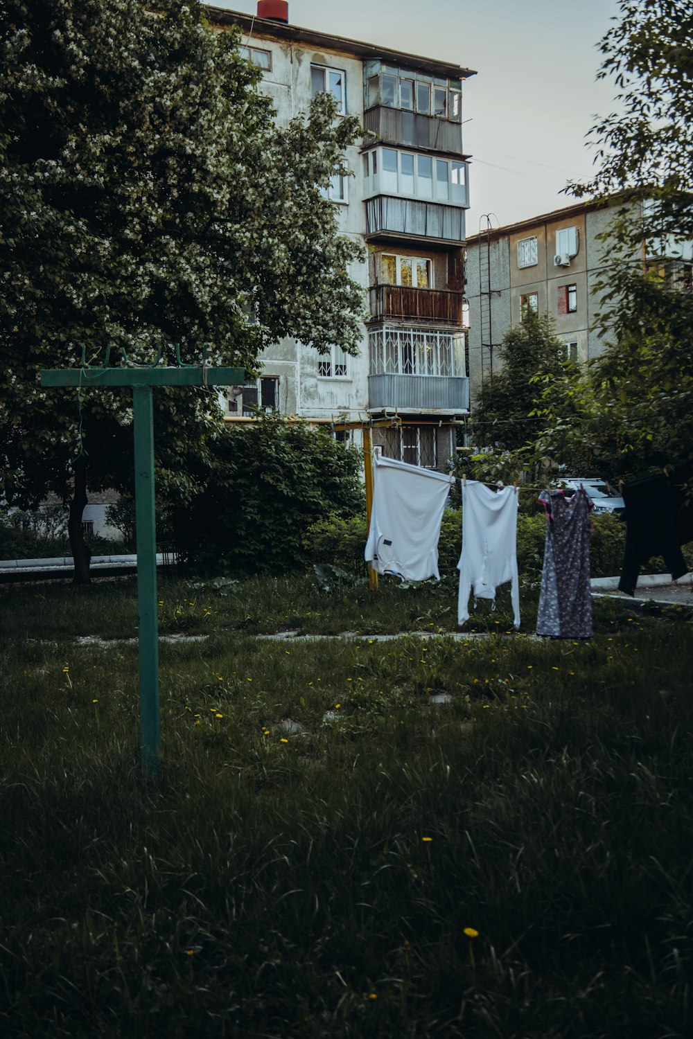 a backyard with a swing set and a house in the background