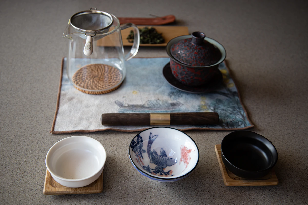 Gongfu tea brewing accessories and leaves on a wooden tray