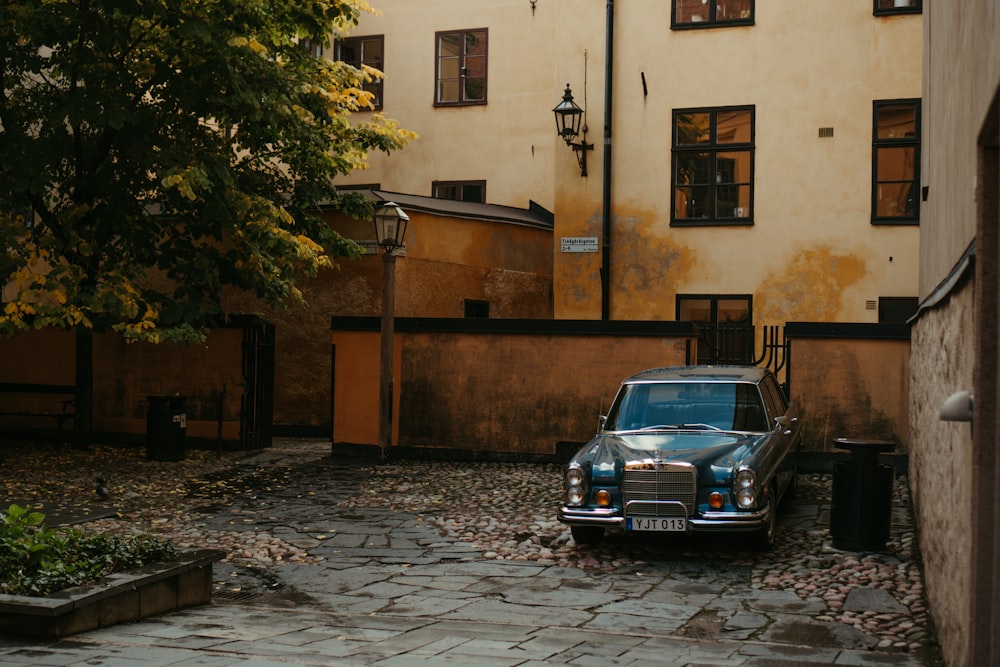 a car parked on a cobblestone street