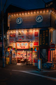 A vibrant storefront featuring bold LED signboards glowing warmly at dusk.