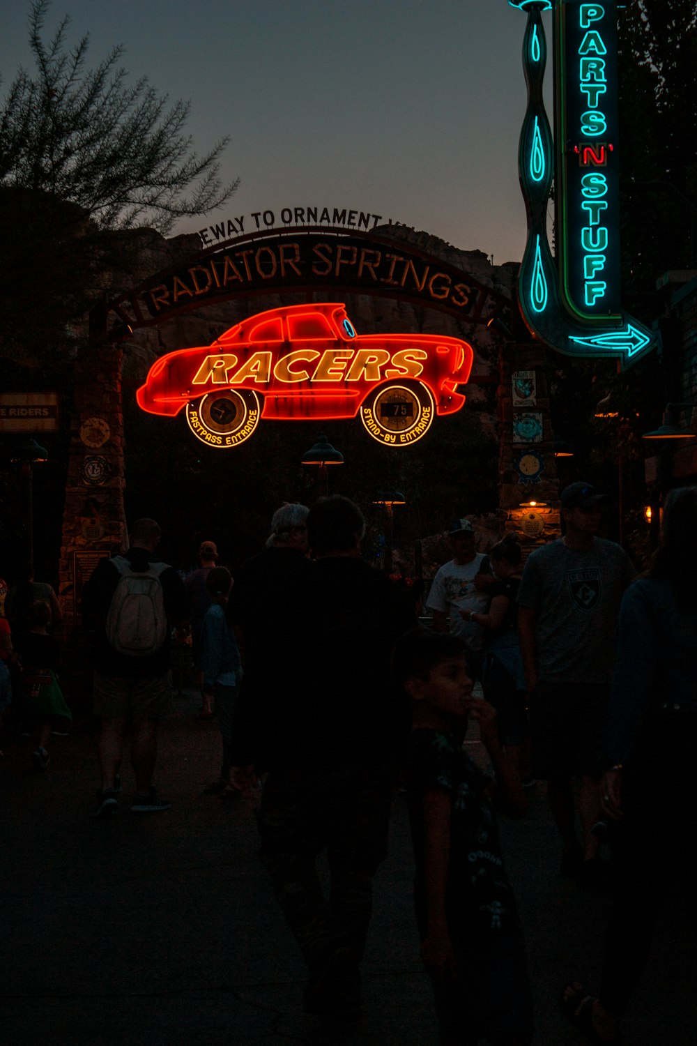 a crowd of people in front of a sign