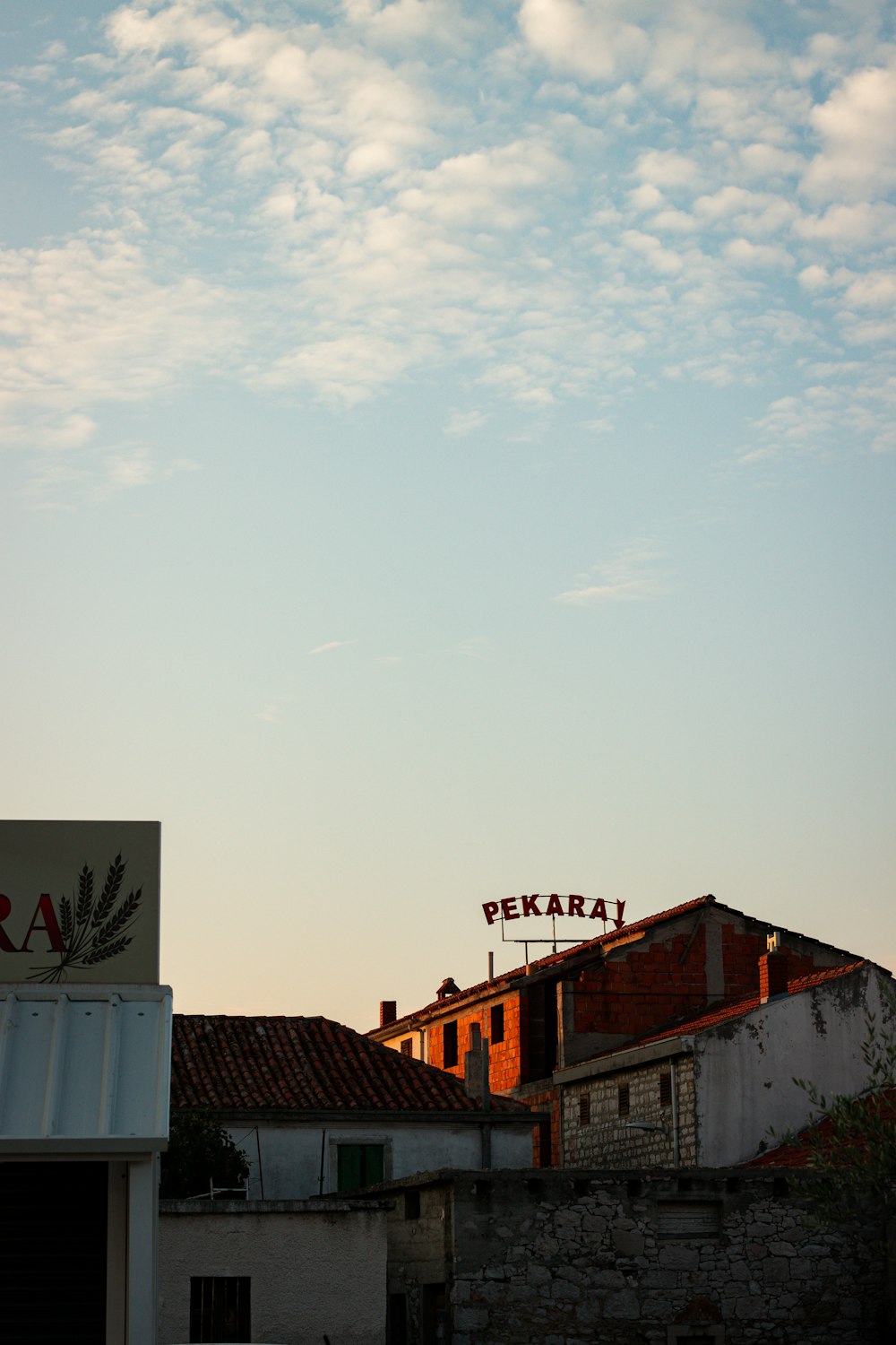 a group of buildings with a sign on top