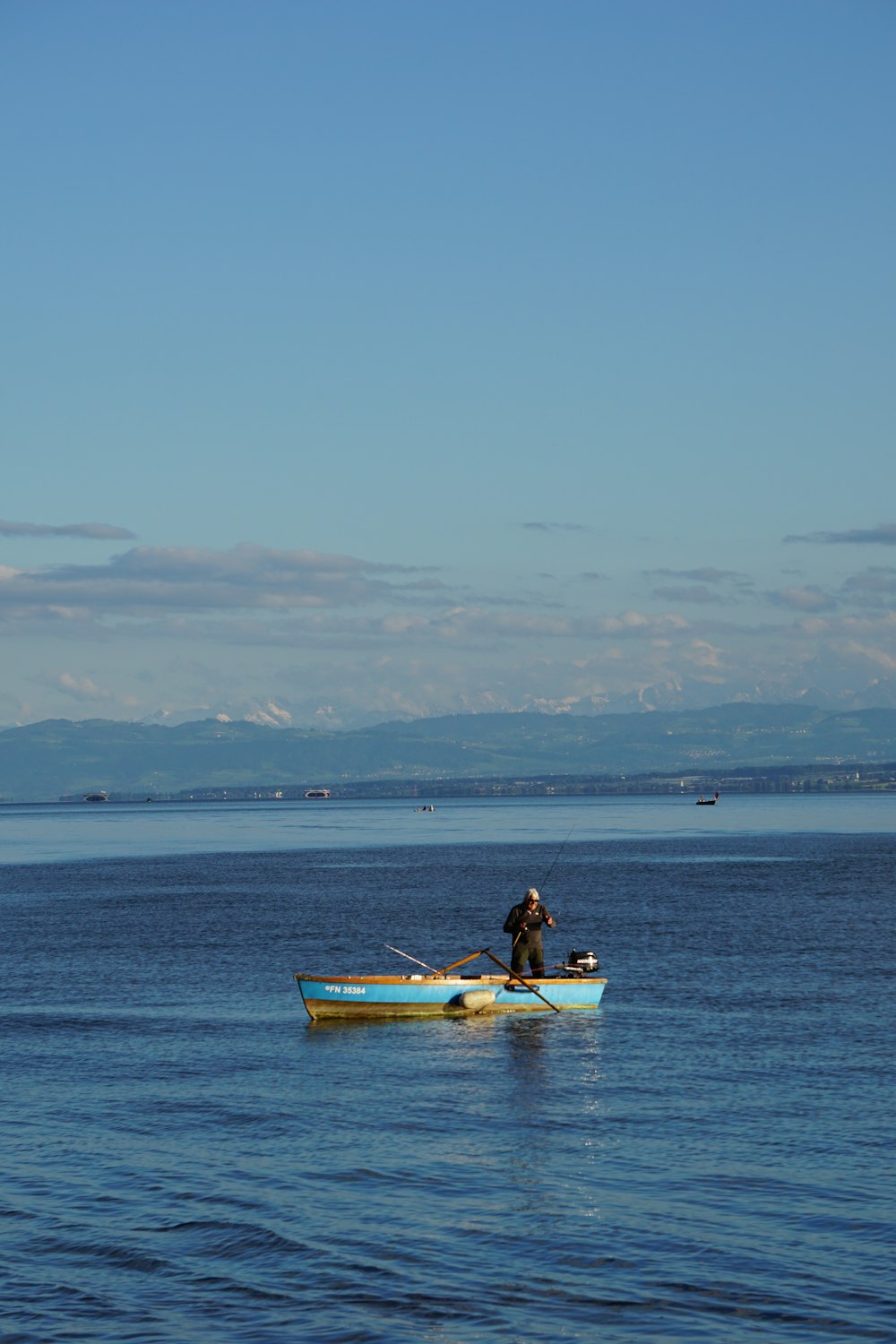 a couple of people on a boat in the water