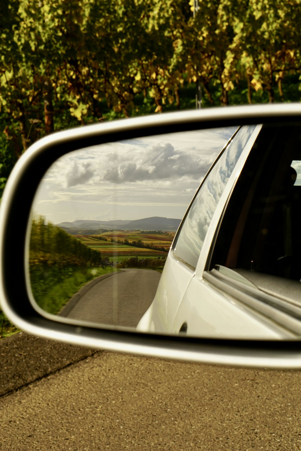a side view mirror showing a car