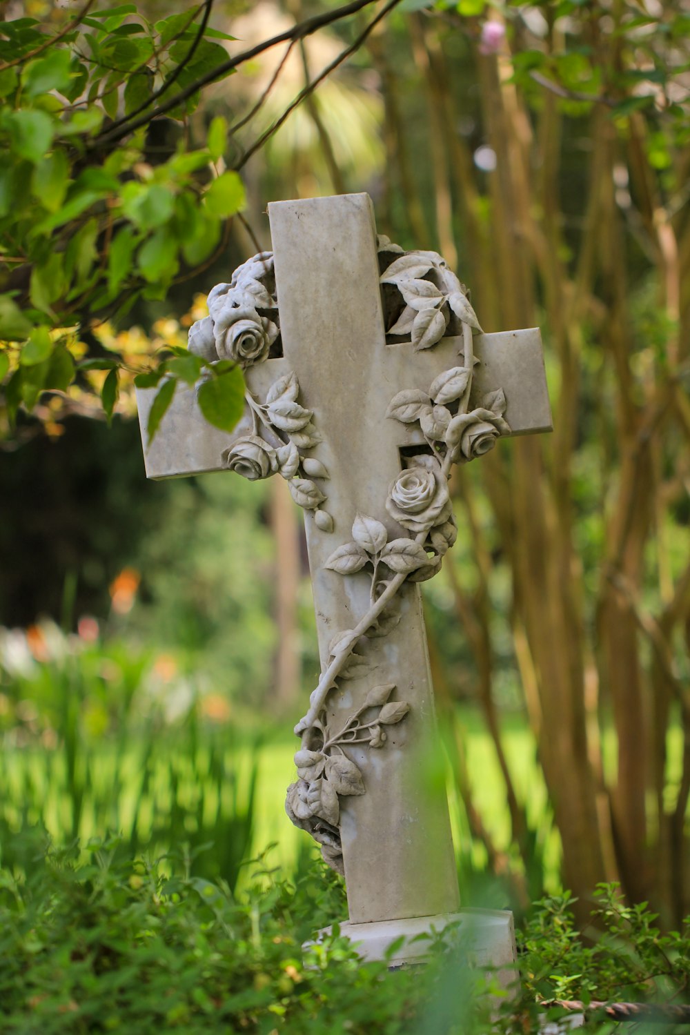 a cross with a statue of a person on it