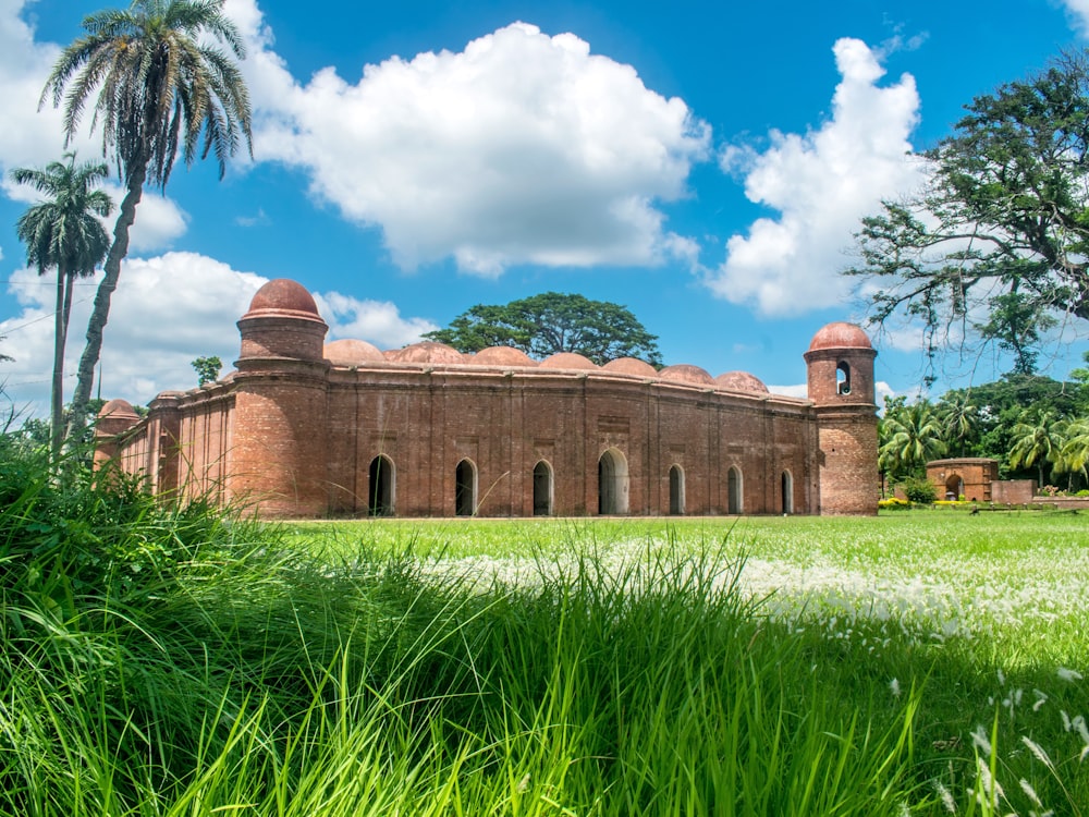 Sixty Dome Mosque with a grass field