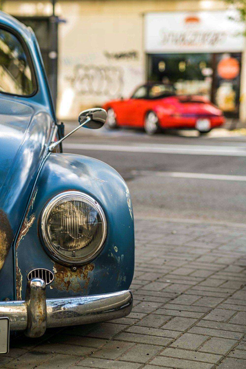 a blue car parked on a street