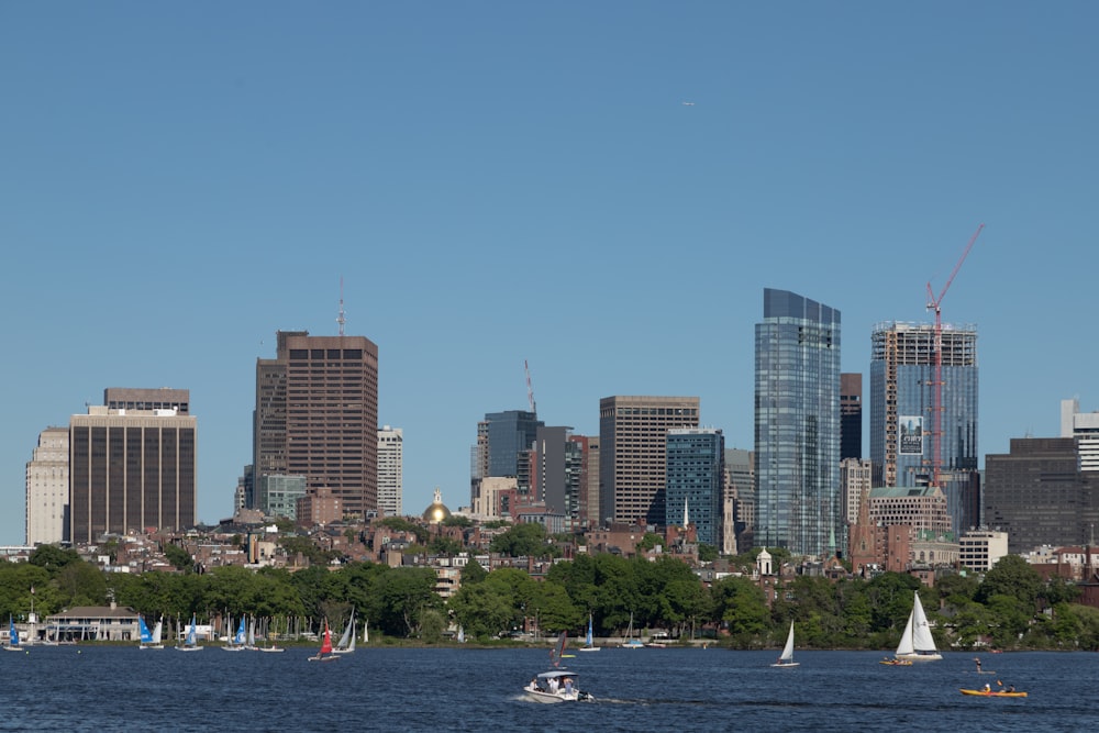 a city skyline with sailboats