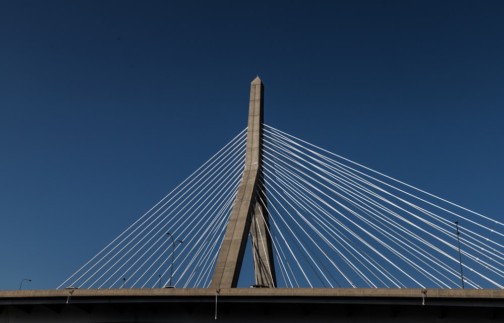 a large bridge with cables with Leonard P. Zakim Bunker Hill Memorial Bridge in the background