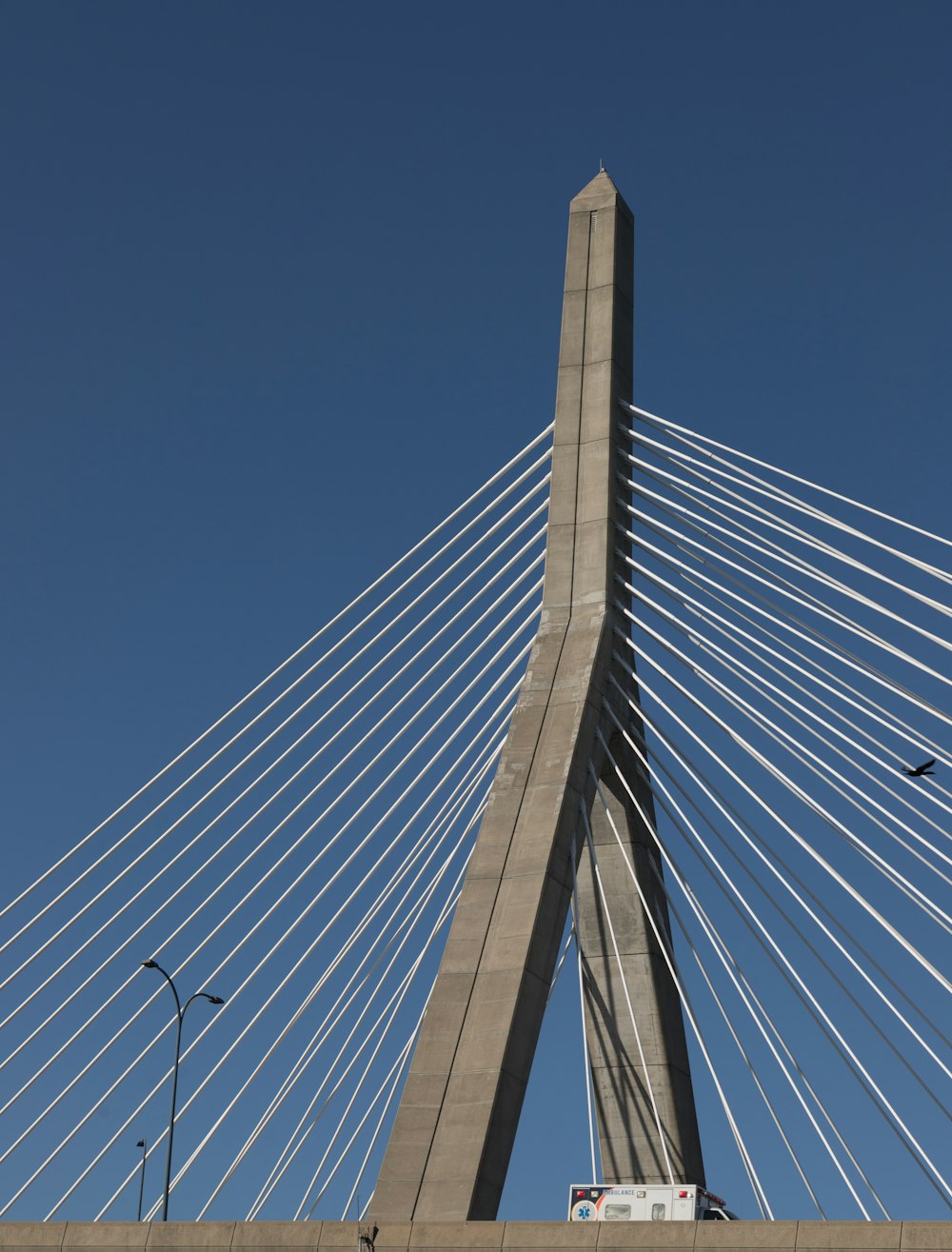 a large bridge with cables with Leonard P. Zakim Bunker Hill Memorial Bridge in the background
