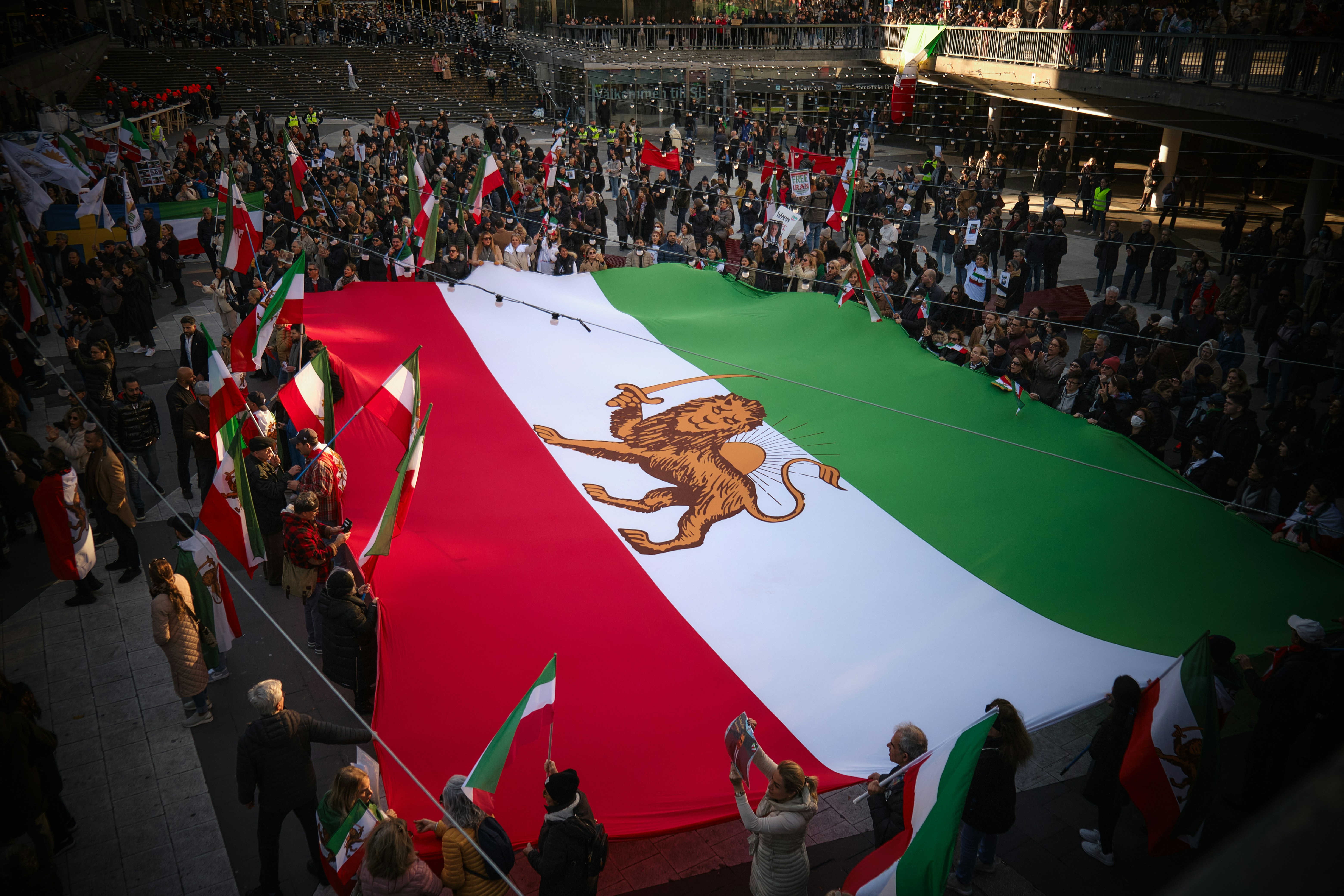 a large crowd of people holding flags