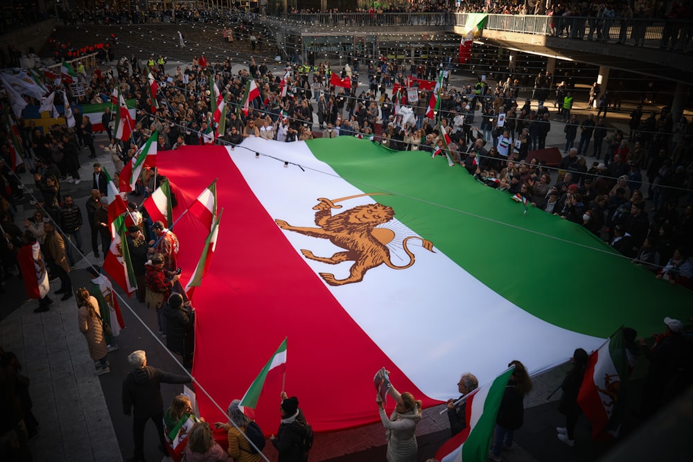 a large crowd of people holding flags