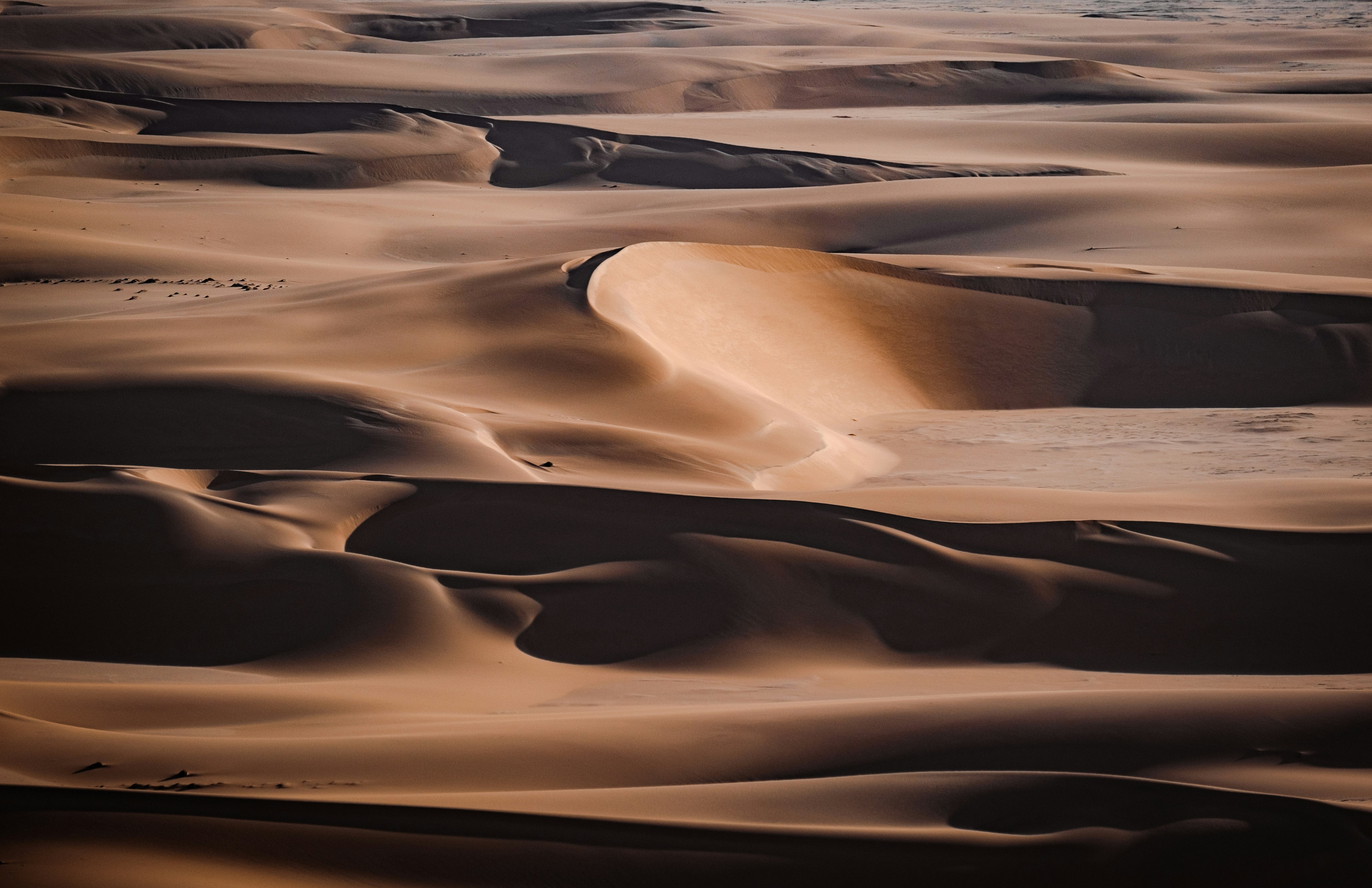 a desert with sand, light and shadows in the desert