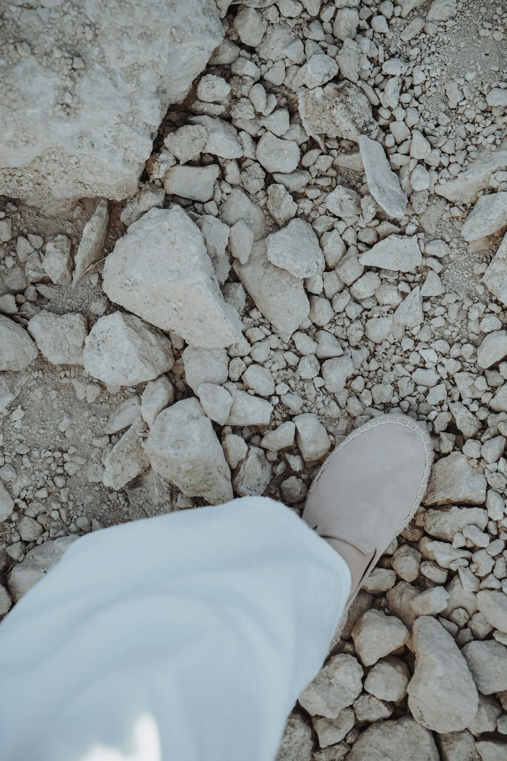 a shoe on a rocky surface