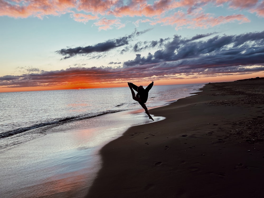a person jumping on a beach