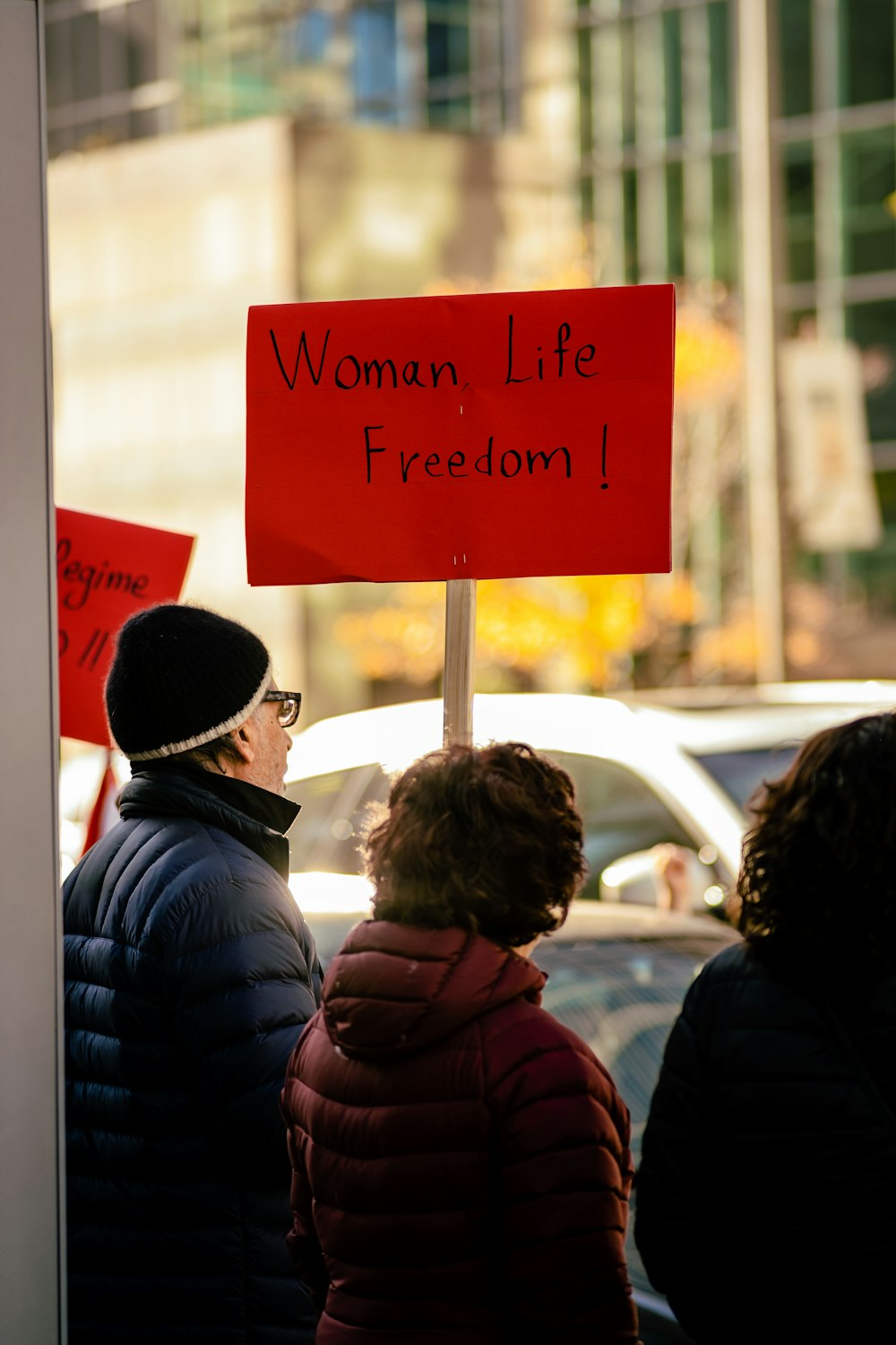 a group of people standing next to a sign