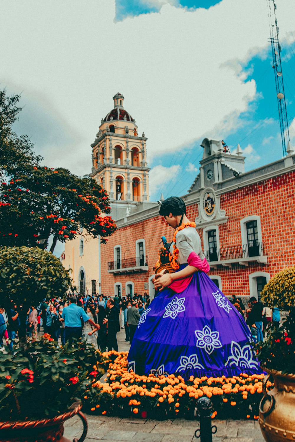 a person in a garment holding a bouquet of flowers