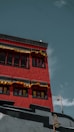 a red building with a gold cross on top
