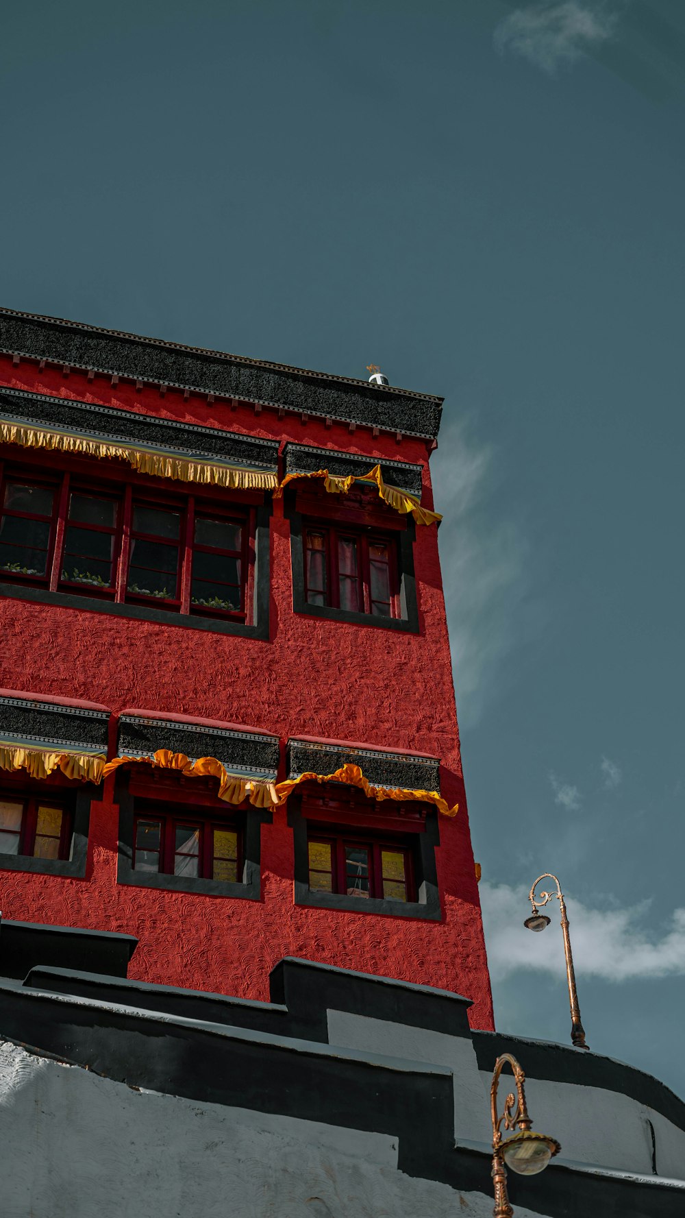 a red building with a gold cross on top